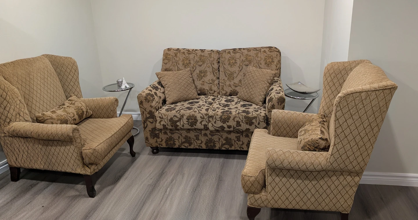 Tan Wingback Armchair with Decorative Pillow