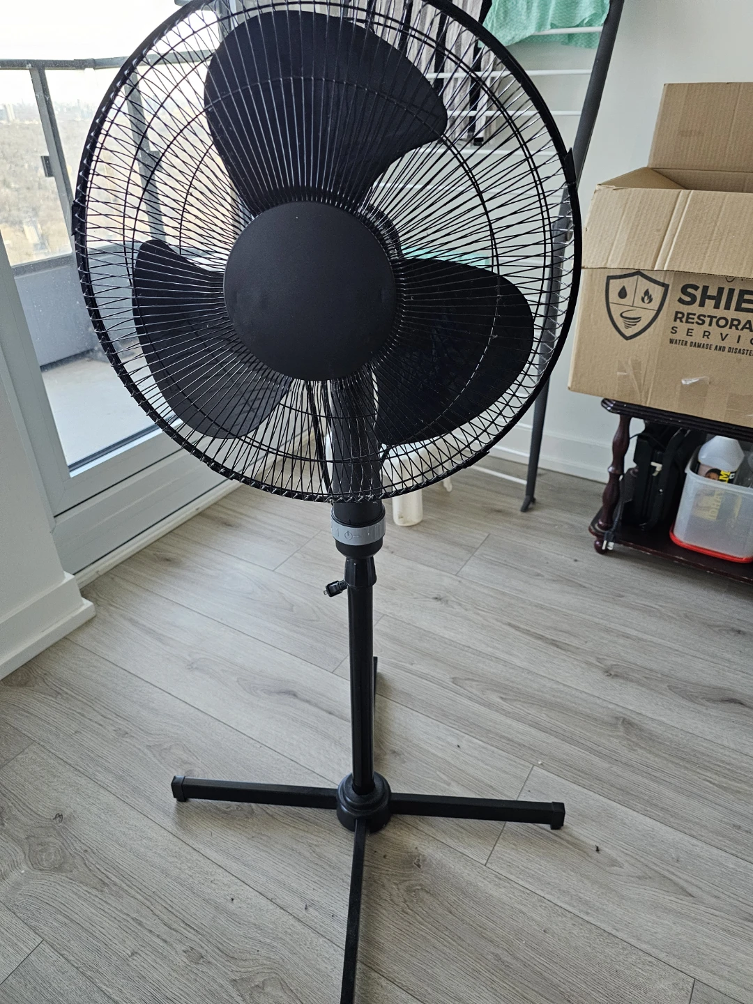 Black oscillating stand fan