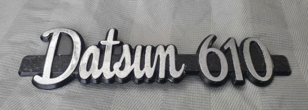 Vintage OEM original Datsun 610 plastic emblem