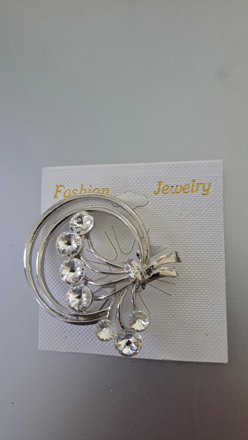 Silver tone brooch with clear rhinestones