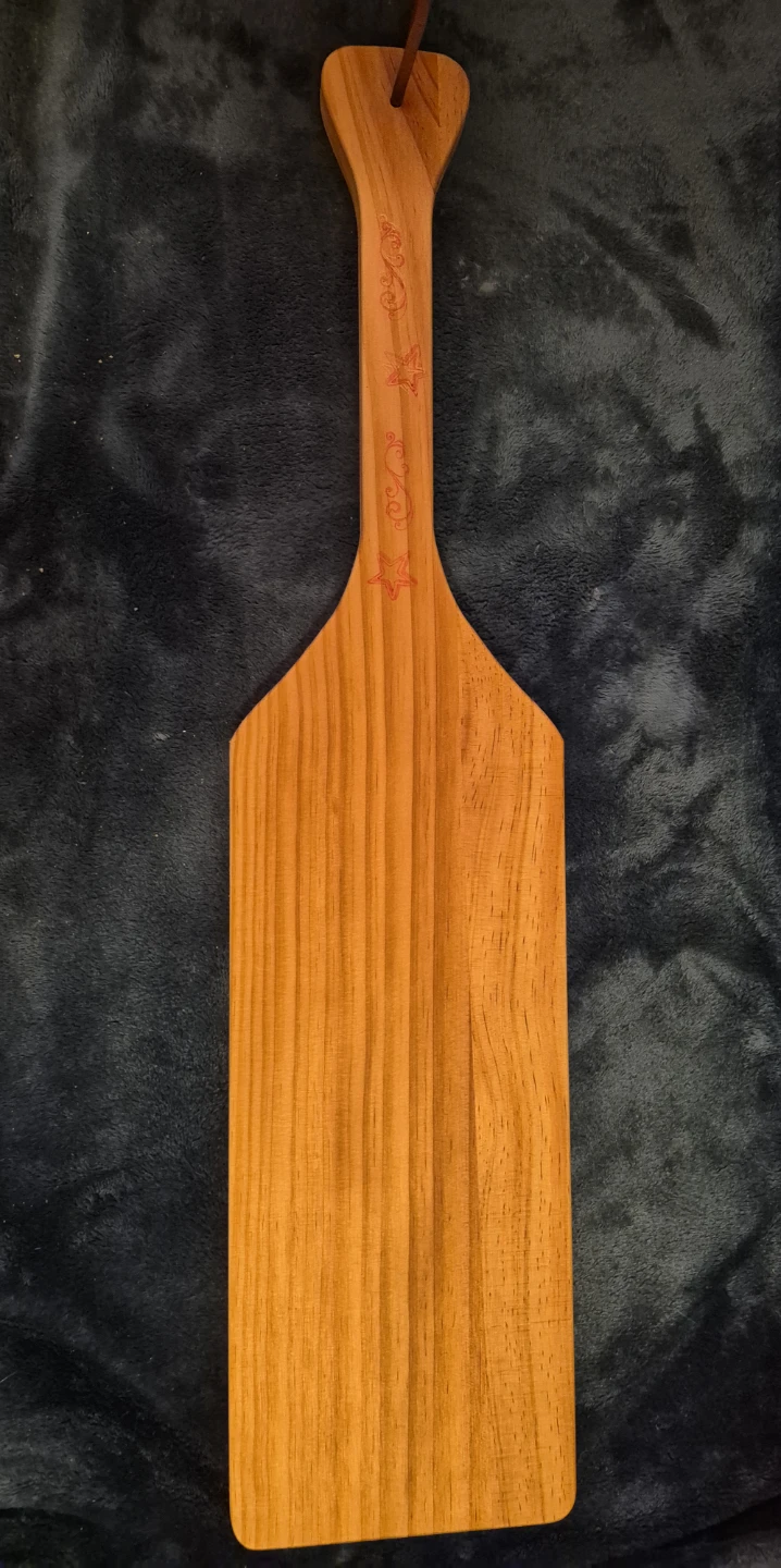 Wooden paddle with decorative engraving