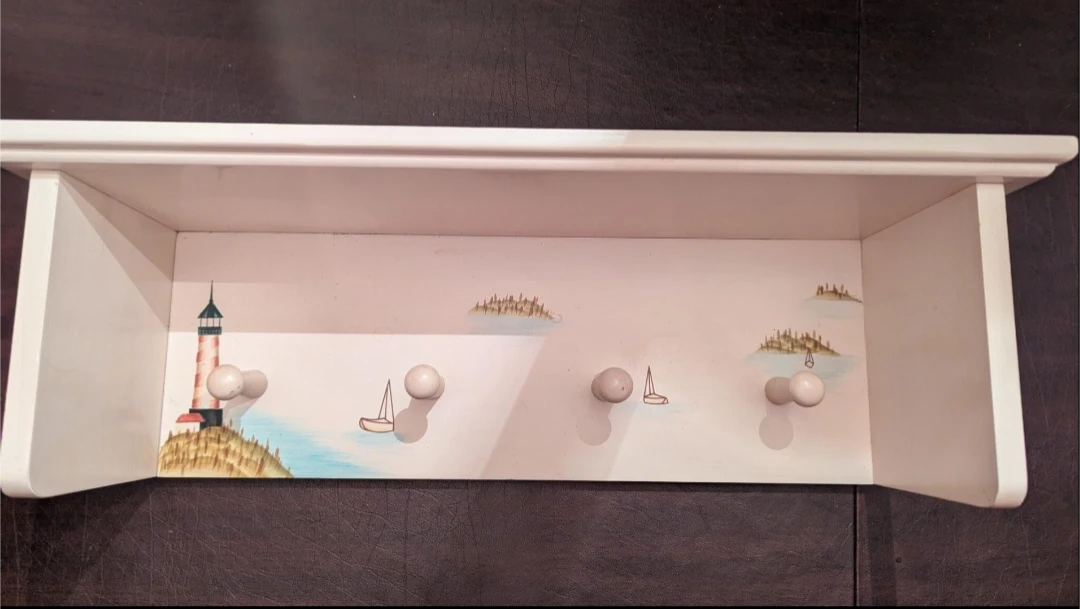 White Wall Shelf with Nautical Decor and Hooks