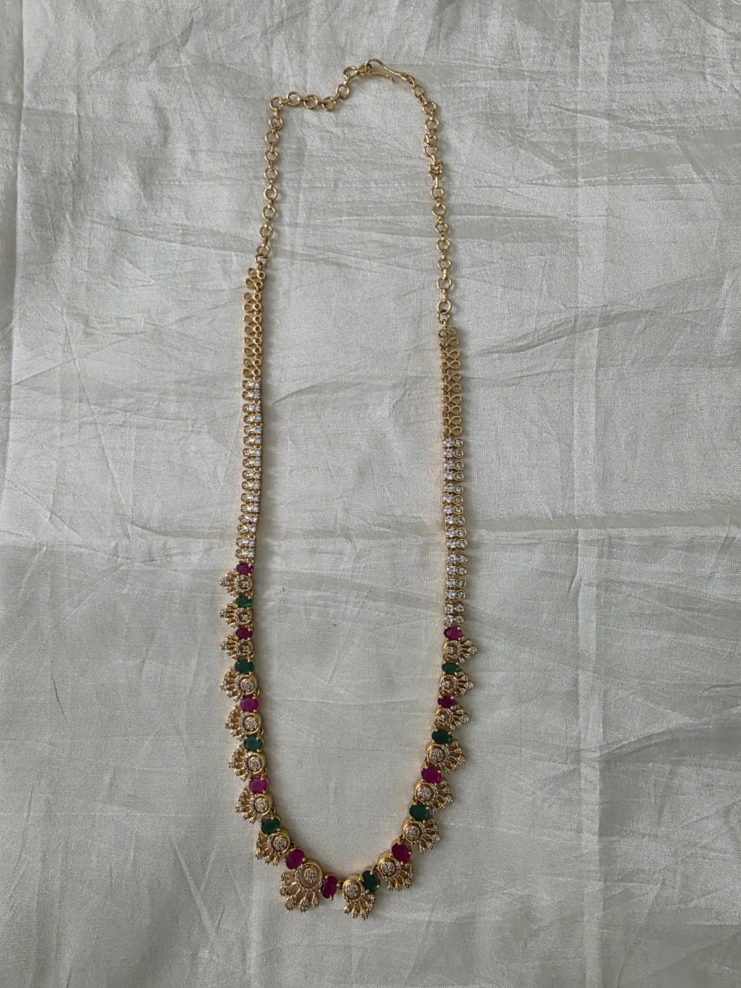 Gold tone necklace with faux ruby, emerald, and diamond accents