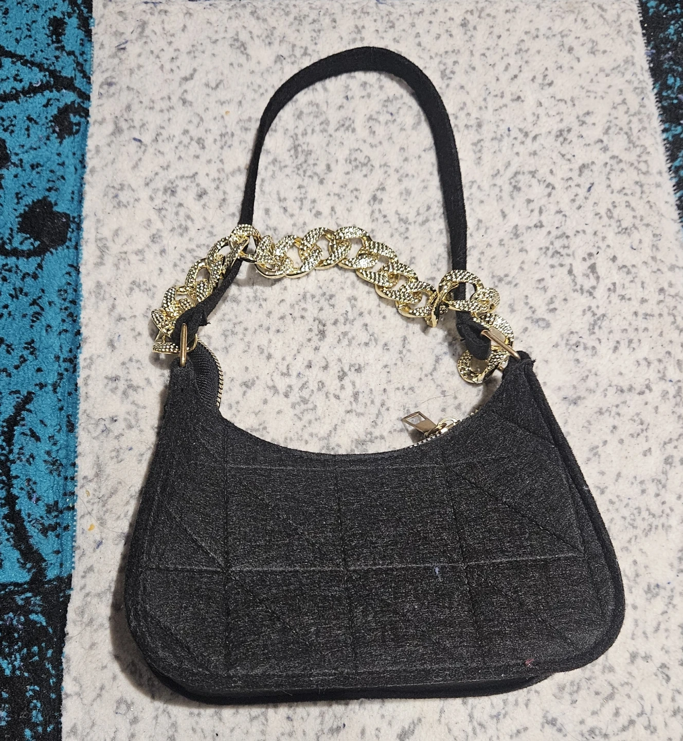 Black mini handbag with gold chain strap