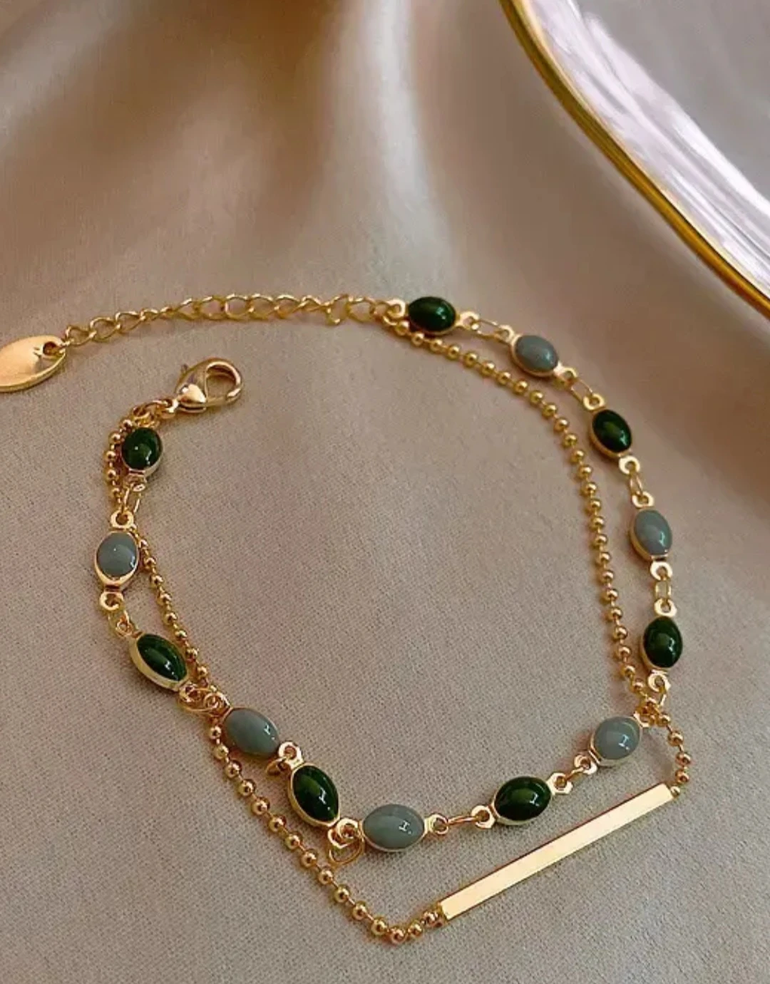 Gold tone multi-strand bracelet with charms