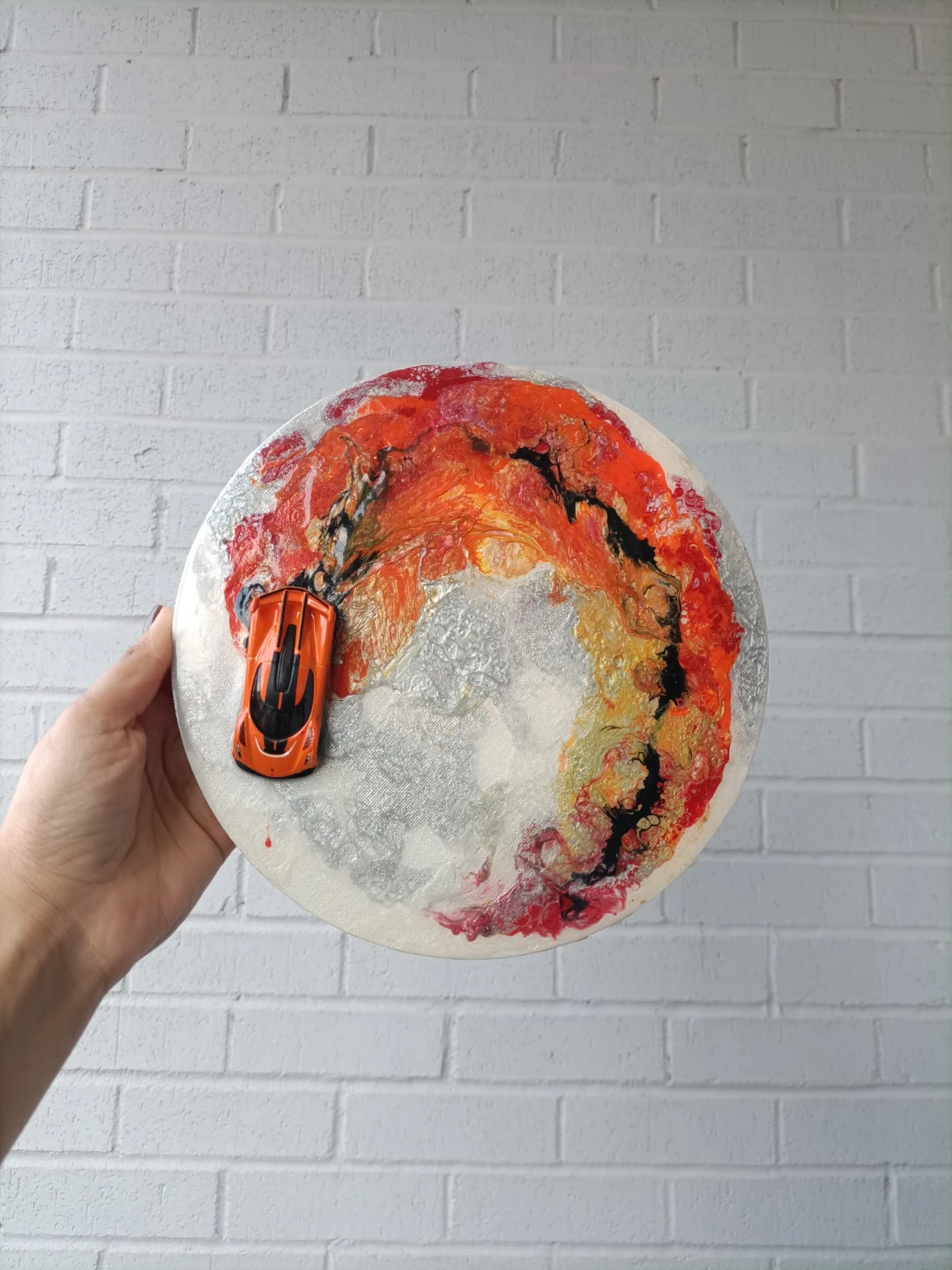 Round Art Piece with Orange Toy Car with resin coating