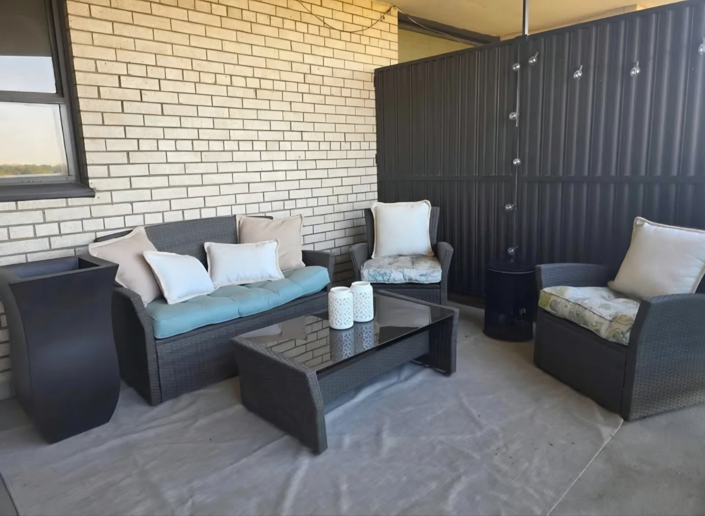 Wicker patio furniture set with cushions and coffee table