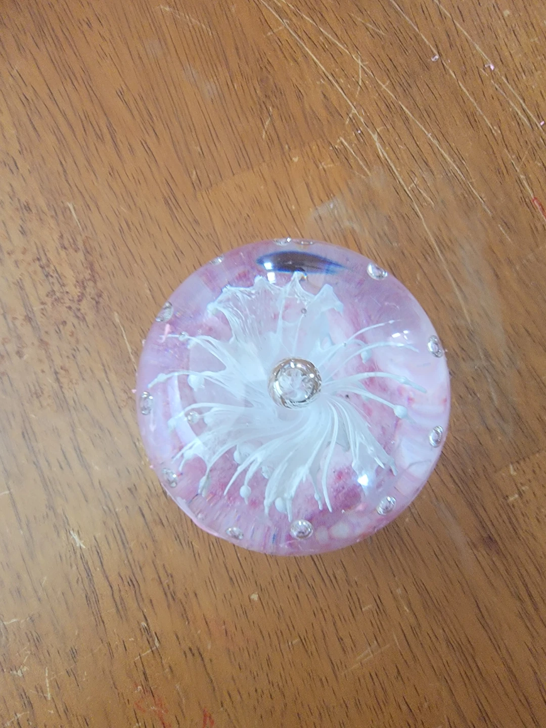 Glass ball with pink and white swirls