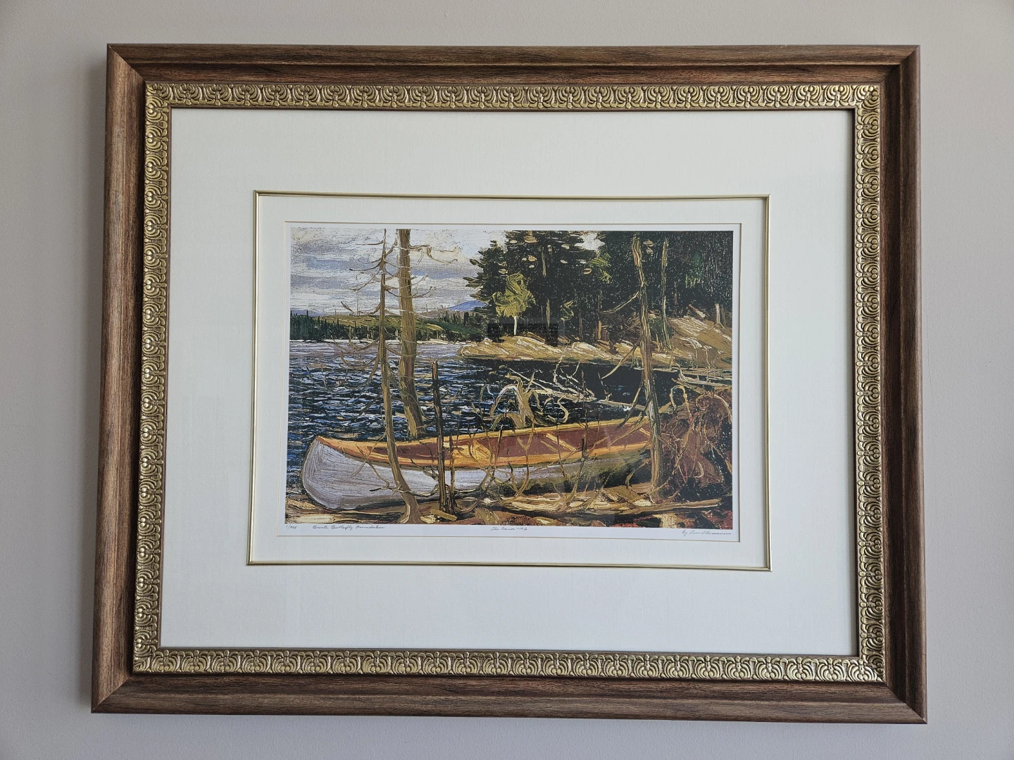 Framed Print of a Canoe by a Lake