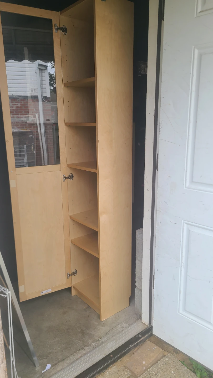 Tall wood storage cabinet with glass door