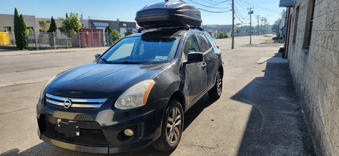 Black Nissan Rogue with Roof Cargo Box