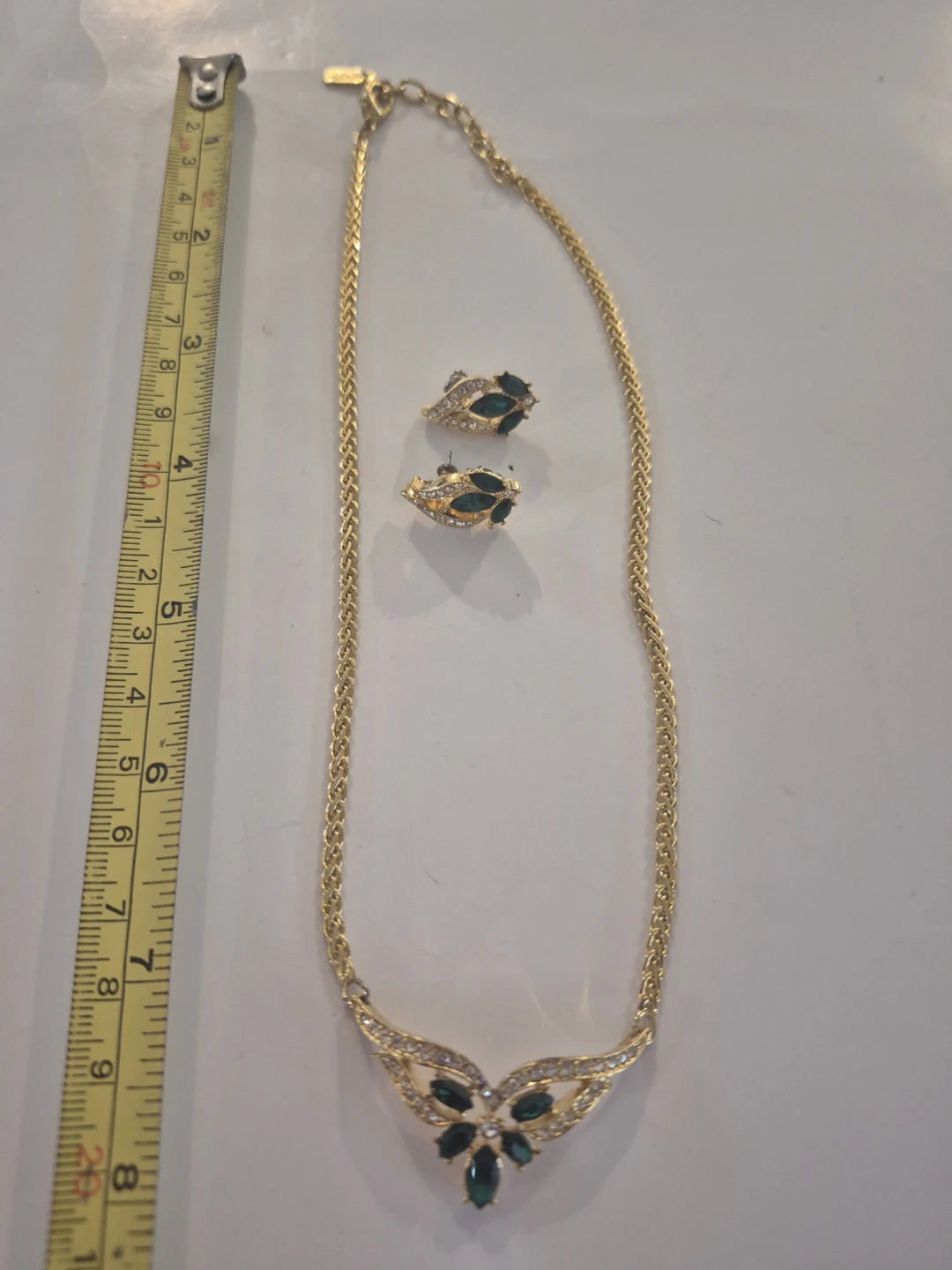 Gold-tone necklace and earrings set with green and clear stones