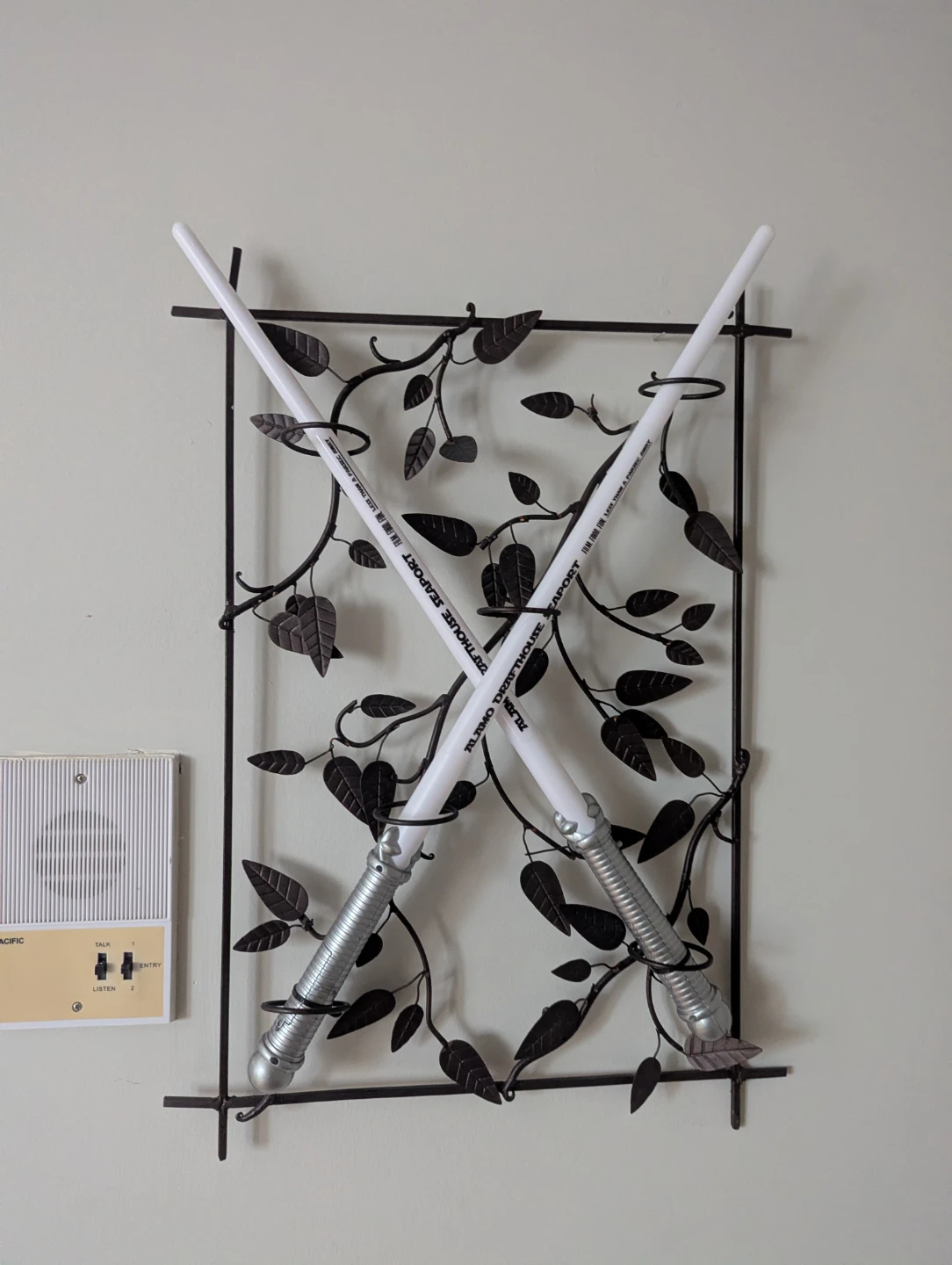 Metal plant rack with decorative lightsabers