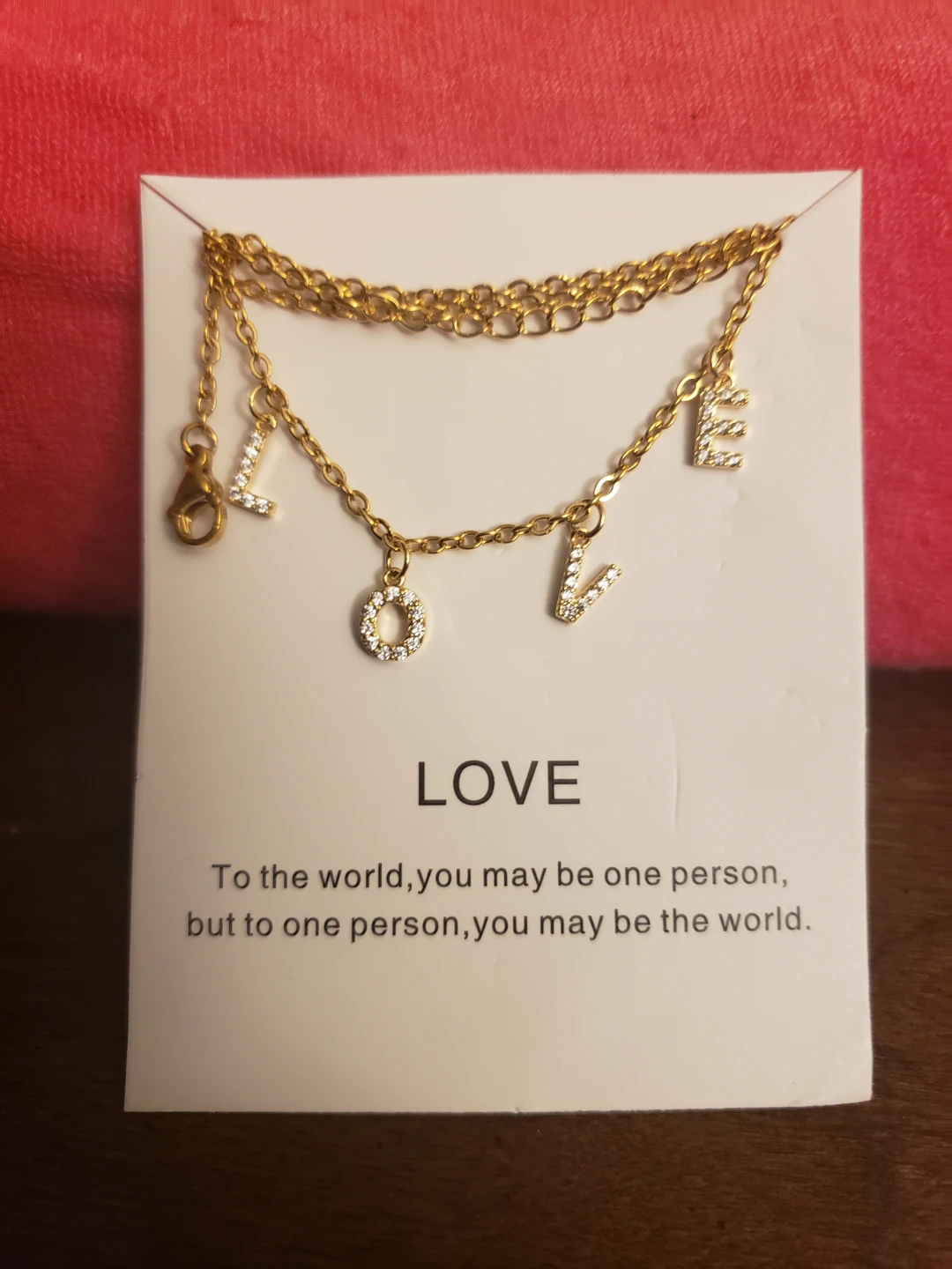 Gold tone "LOVE" necklace with rhinestones