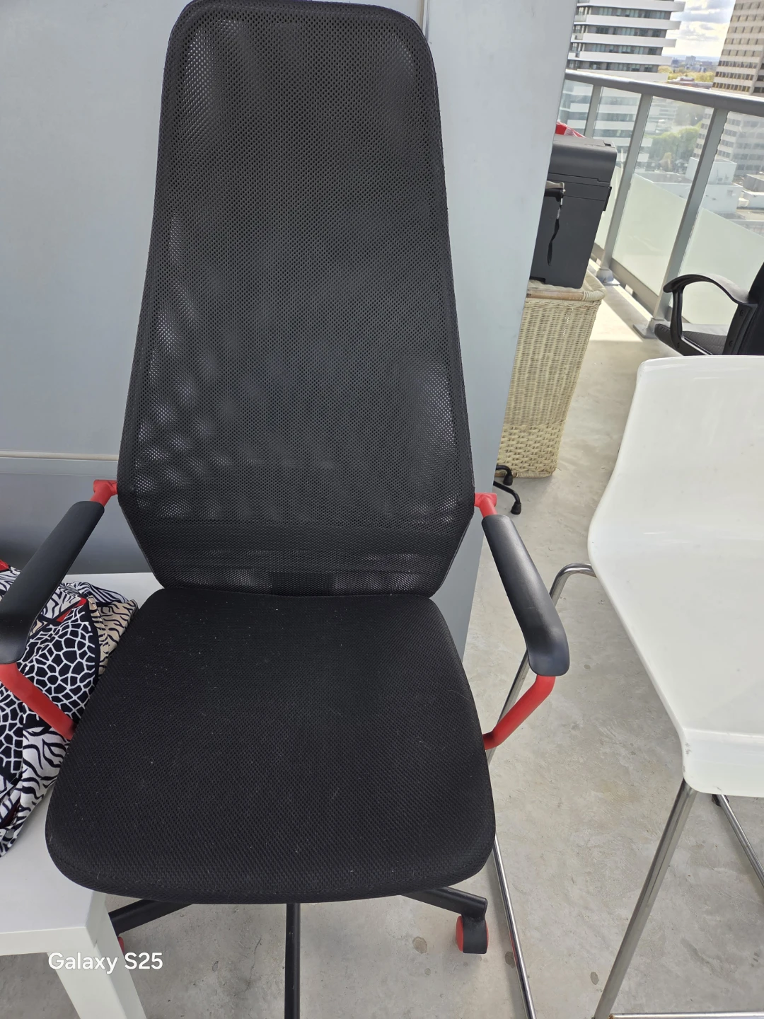 Black mesh office chair with red accents