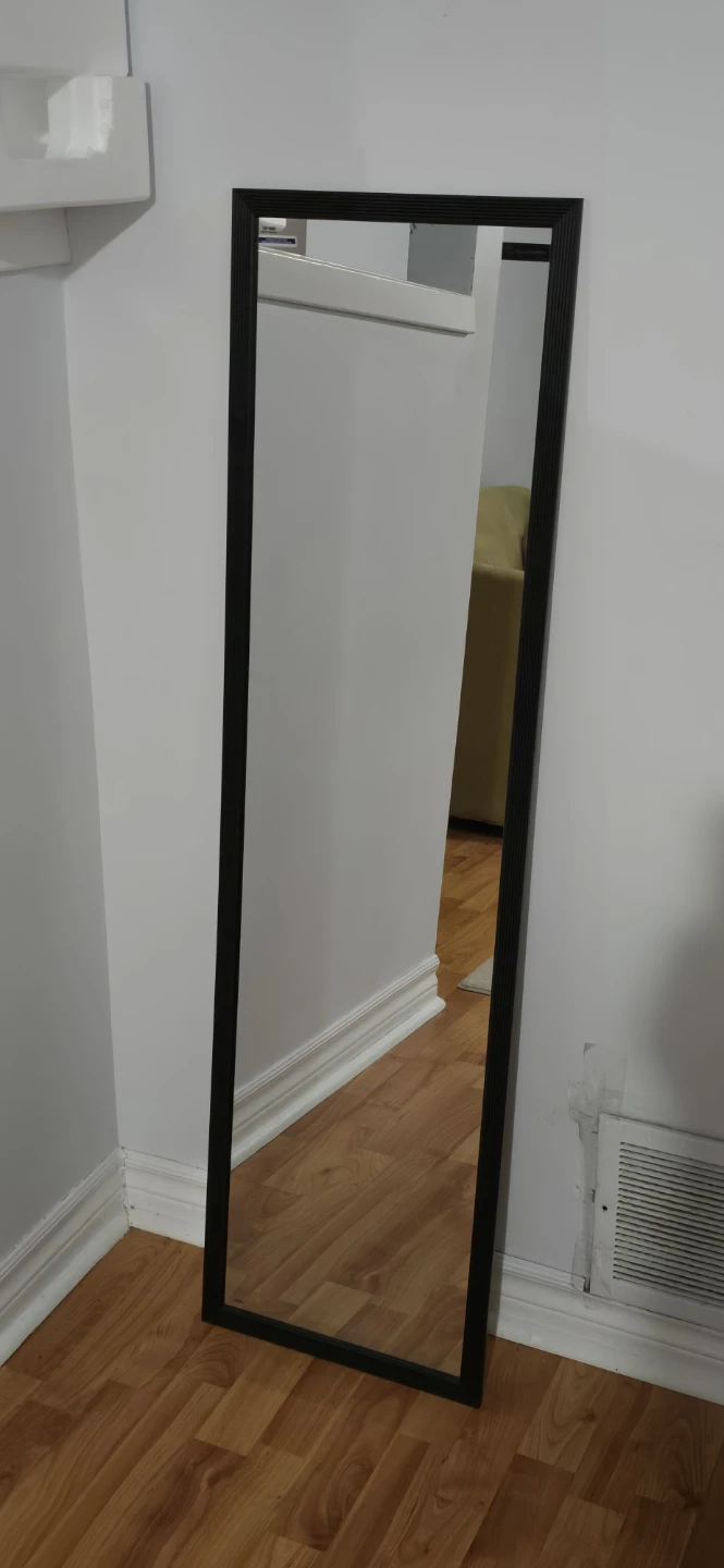 Full-length black framed mirror