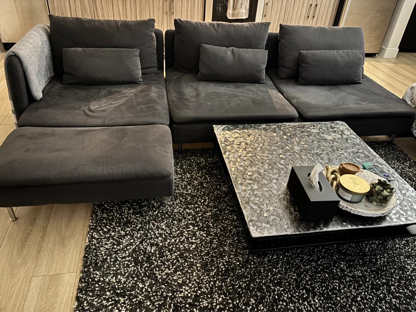 Dark Grey Sectional Sofa with coffee table and rug