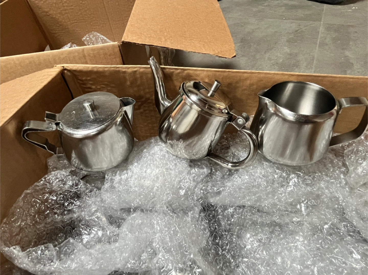 Assorted Creamers, Teapots, and Ramekins