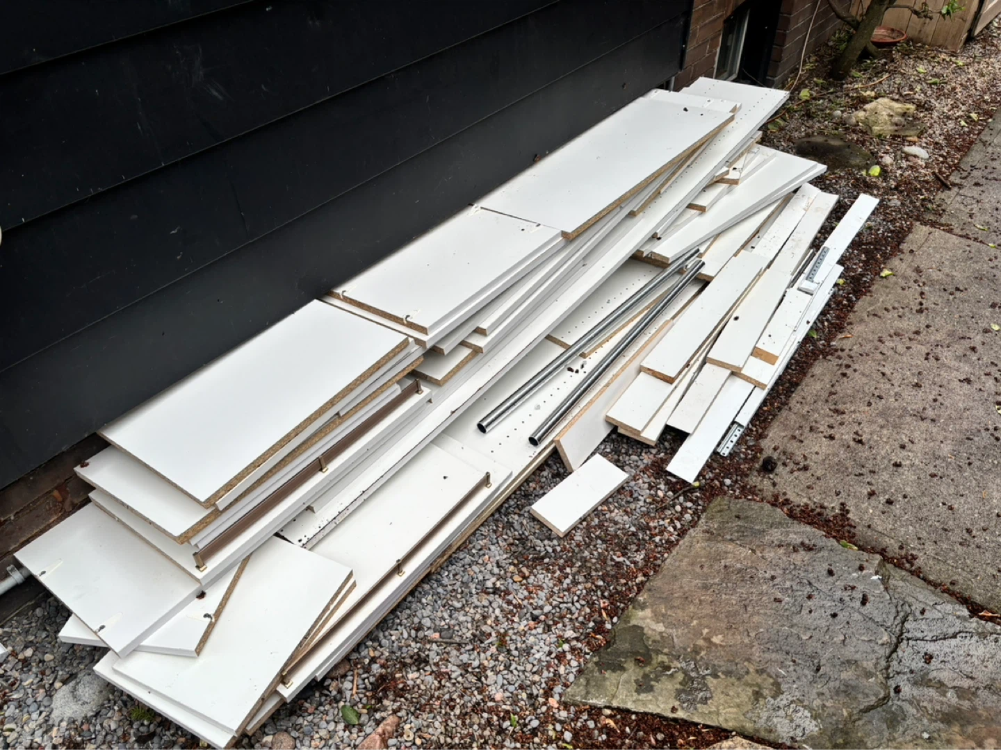 White Shelving Pieces and Metal Rods