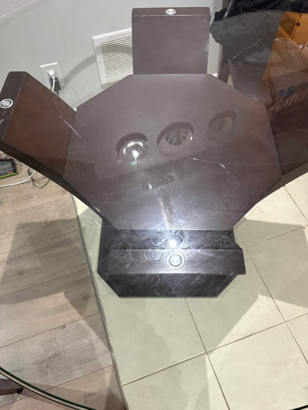 Glass top dining table with dark wood base
