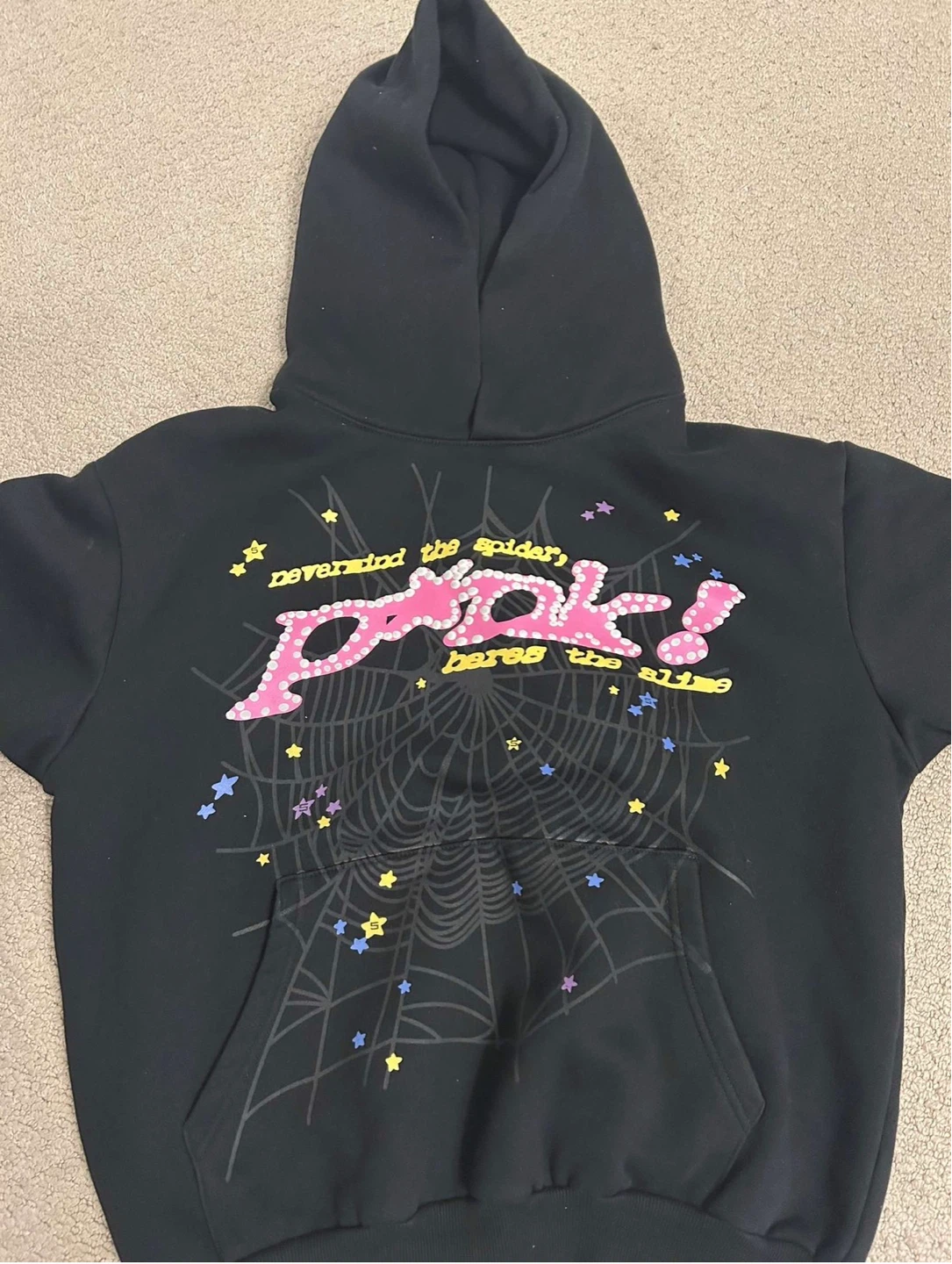 Pink hoodie with spiderweb graphic