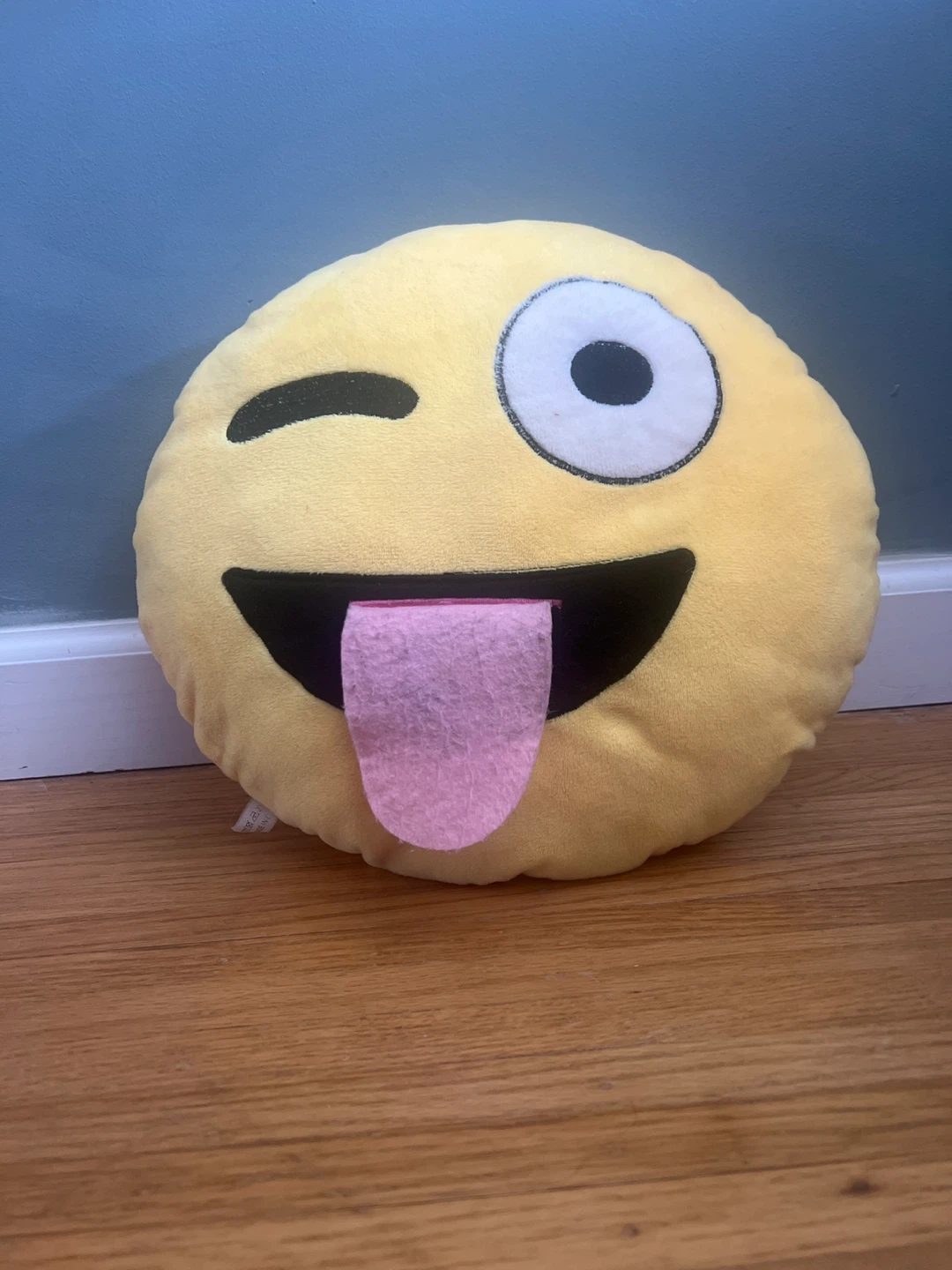 Tongue out winking emoji pillow