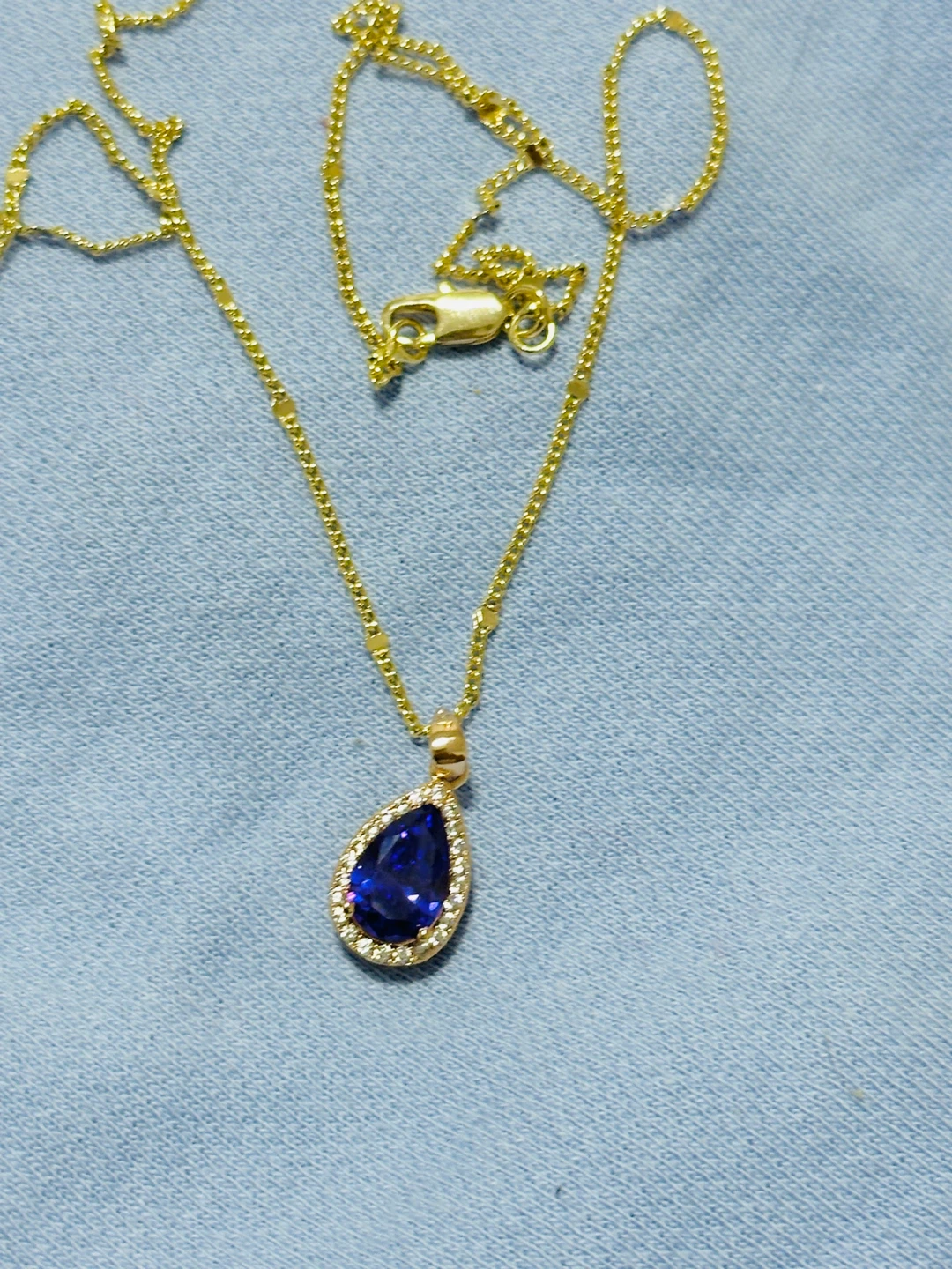 Gold Pendant Necklace with Blue Gemstone and Diamonds