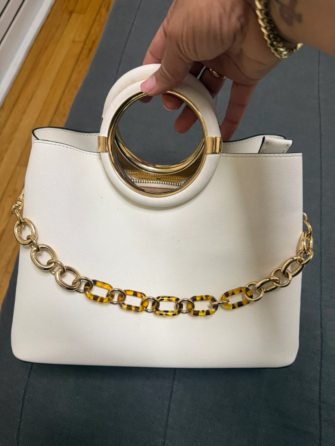 White handbag with gold chain accent Aldo