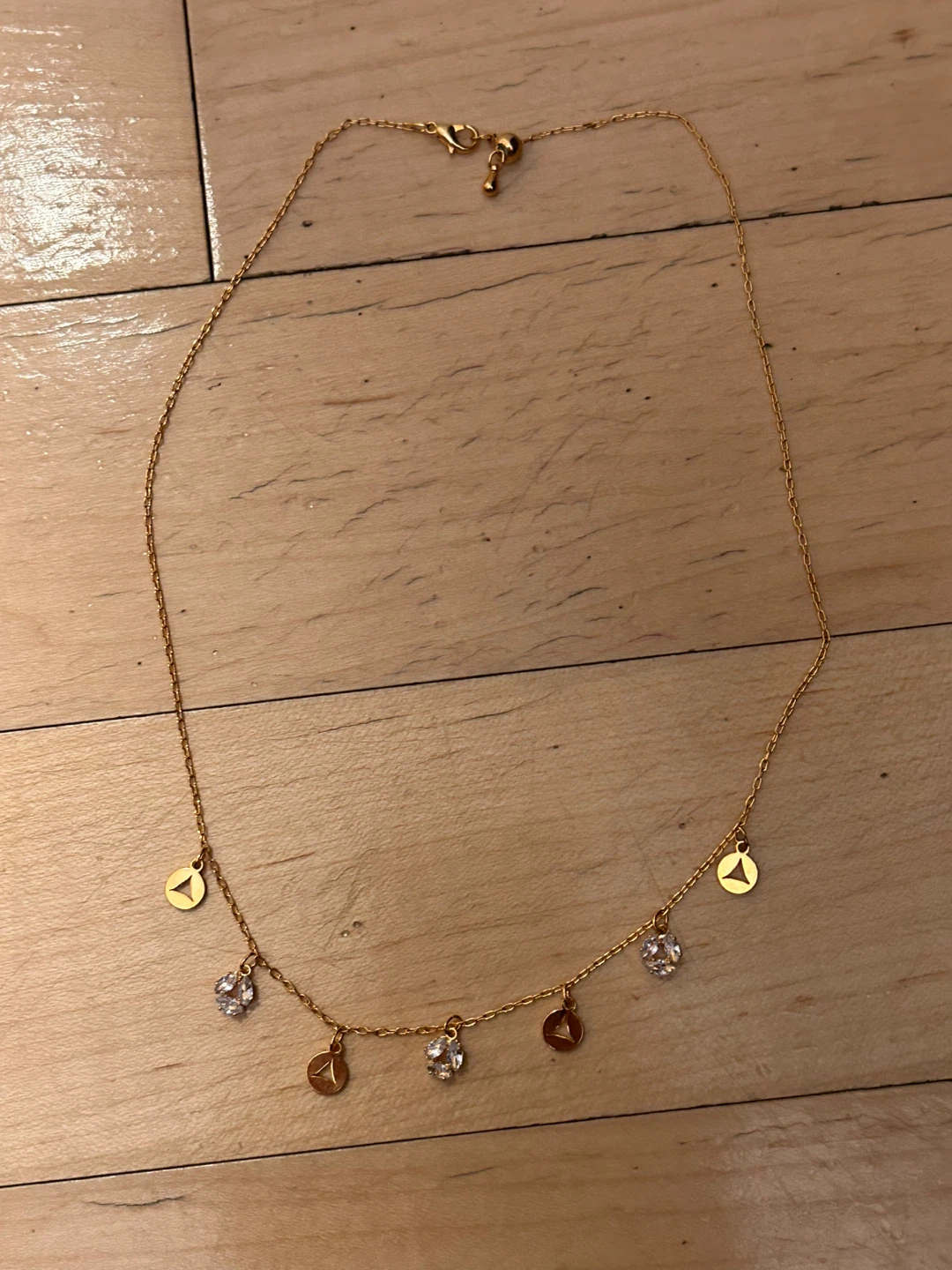 Gold-tone charm necklace with cubic zirconia