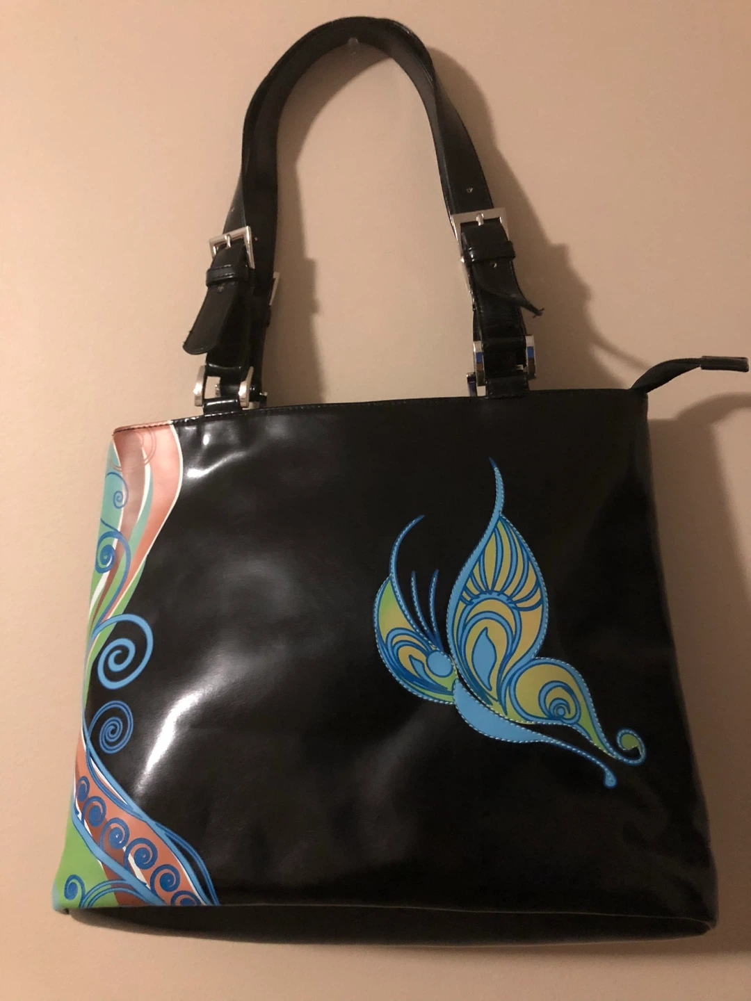 Black patent leather tote bag with butterfly design