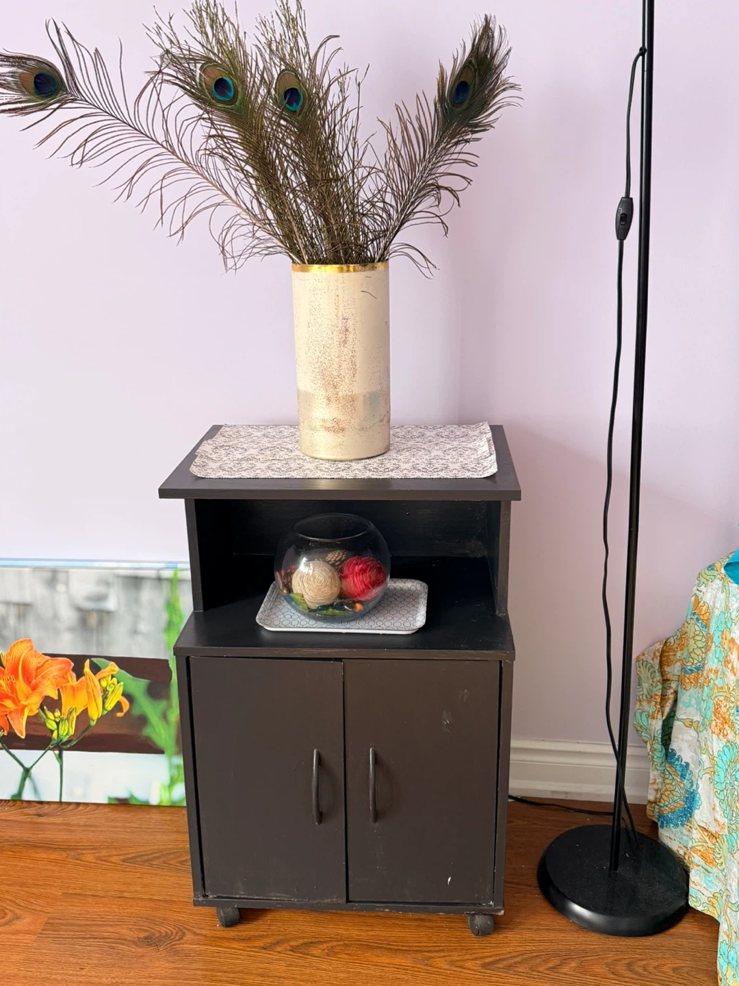 Small dark wood accent cabinet with wheels