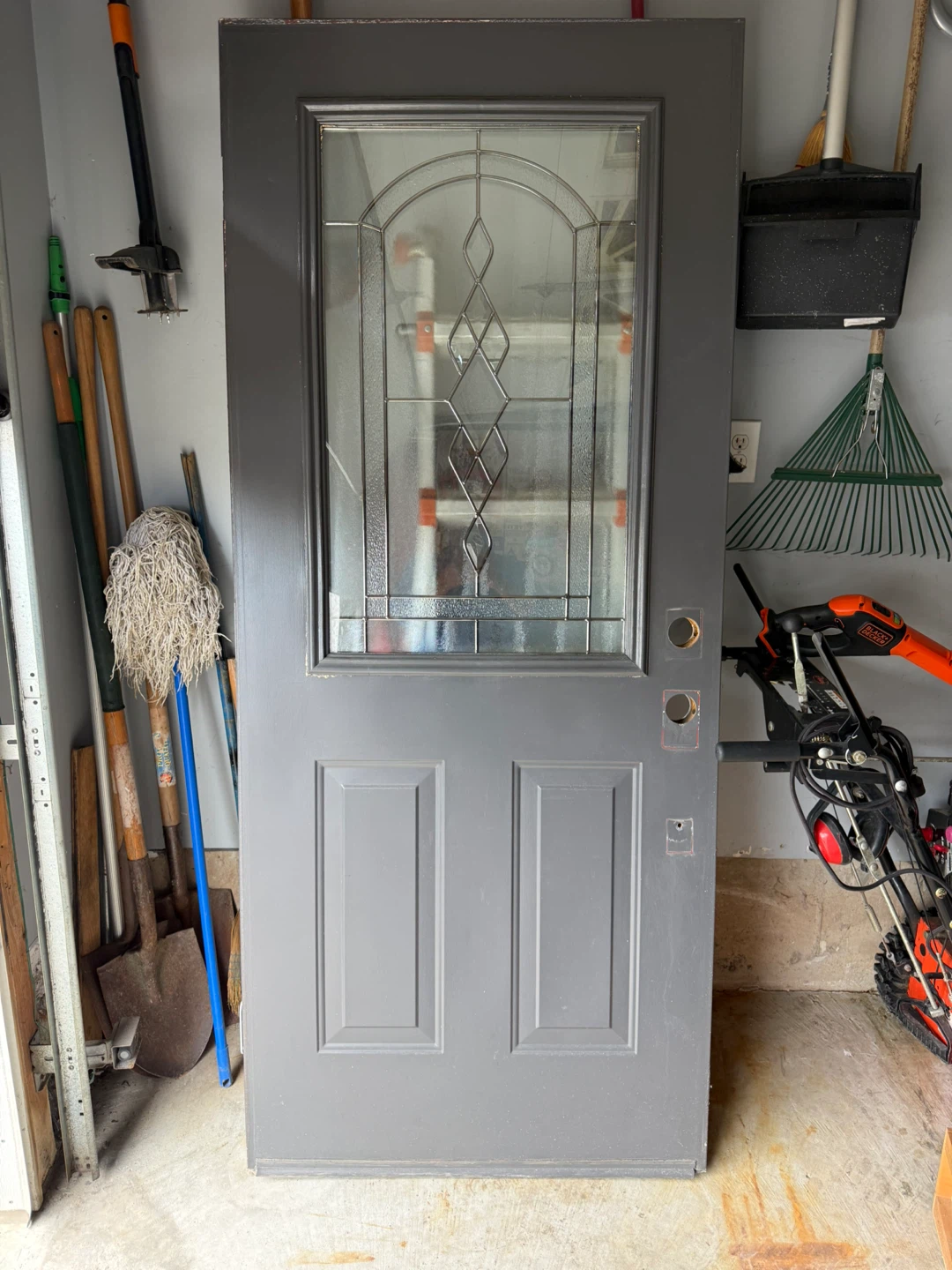 Grey exterior door with decorative glass insert