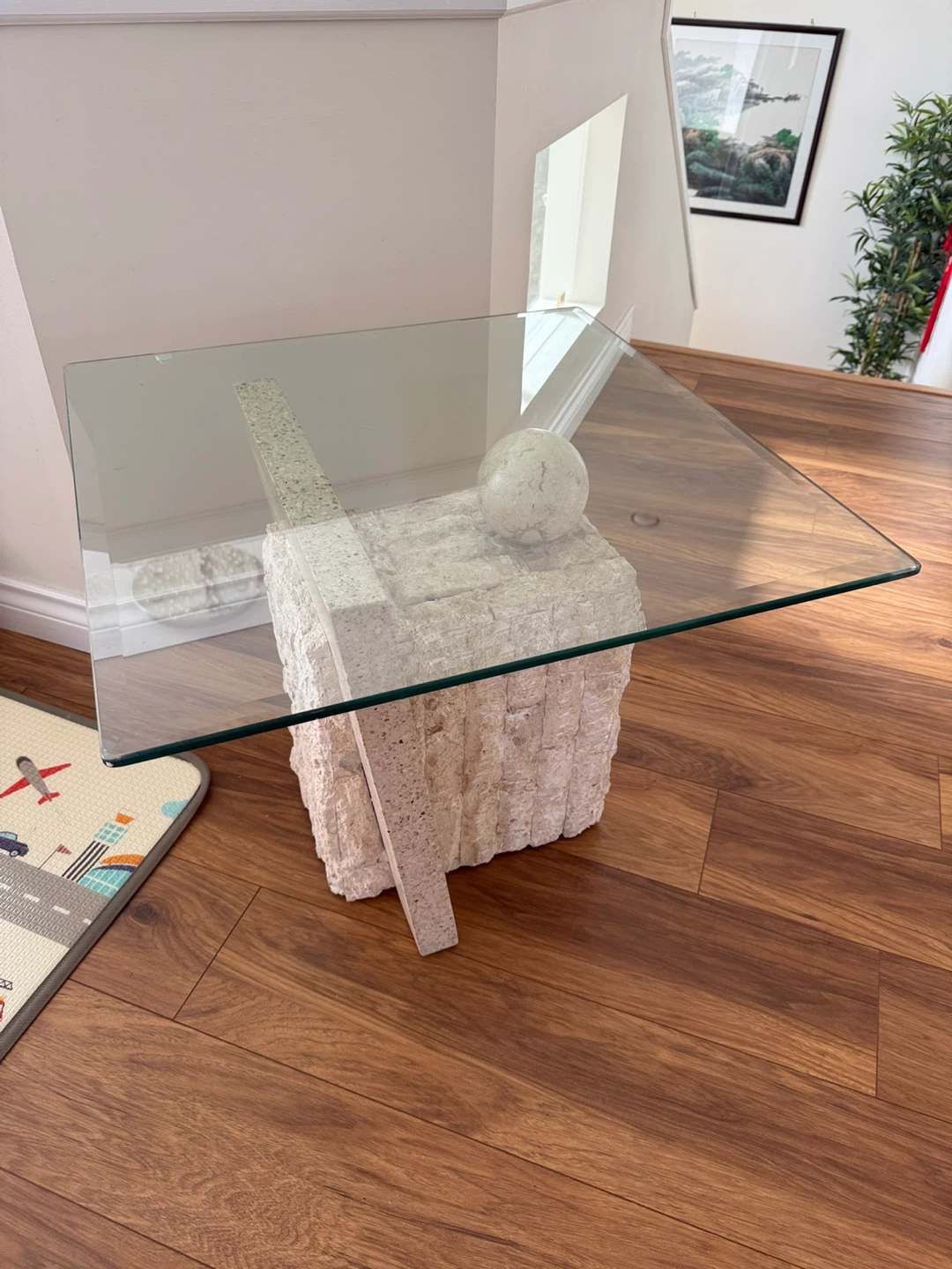 Glass top side table with unique stone base