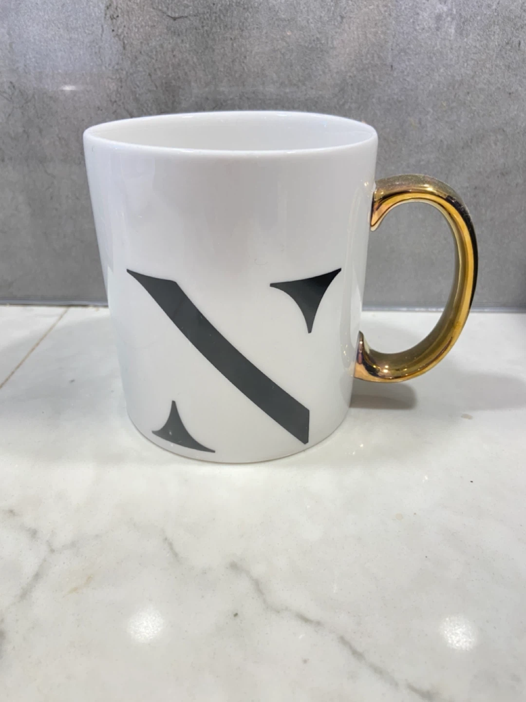 White Mug with Gold Handle and "N" Design