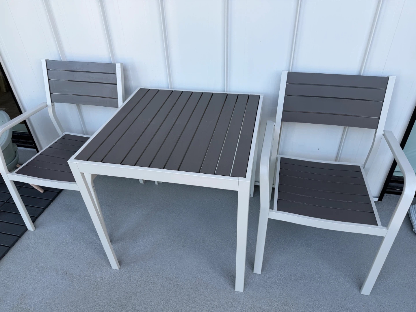 Metal patio chair with grey slats