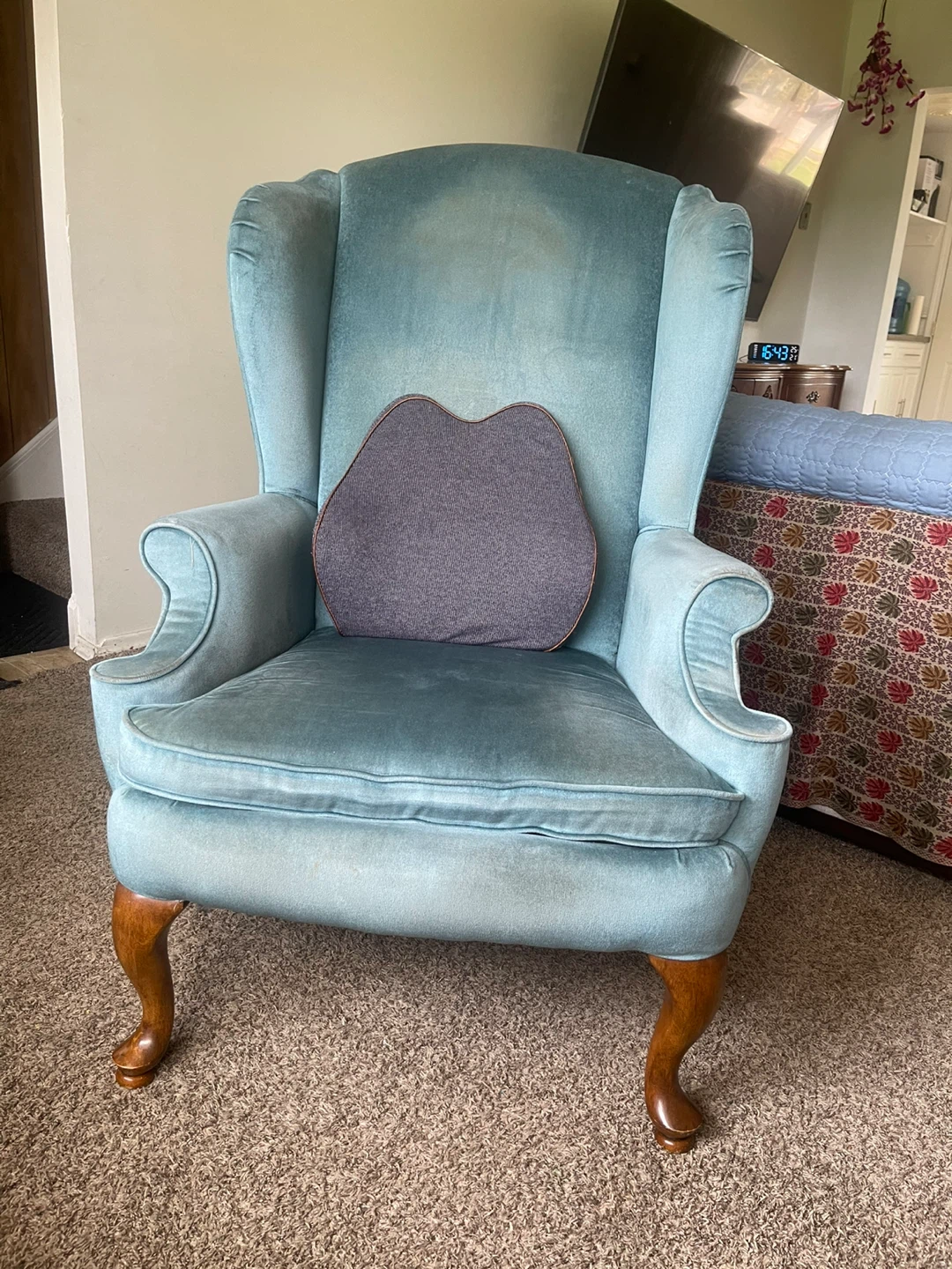 Light Blue Wingback Armchair with Decorative Pillow
