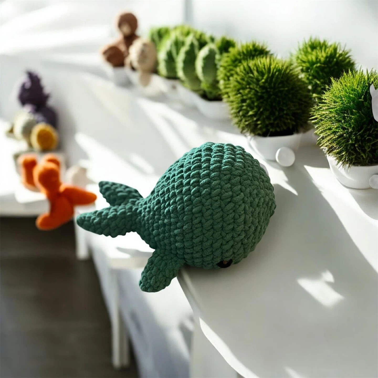 Green knitted whale plush toy