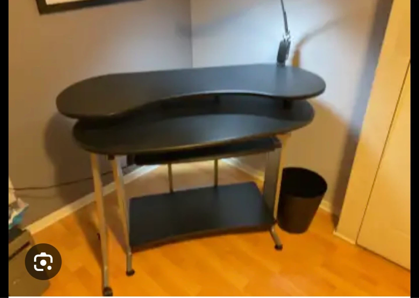 Black computer desk with keyboard tray and shelves