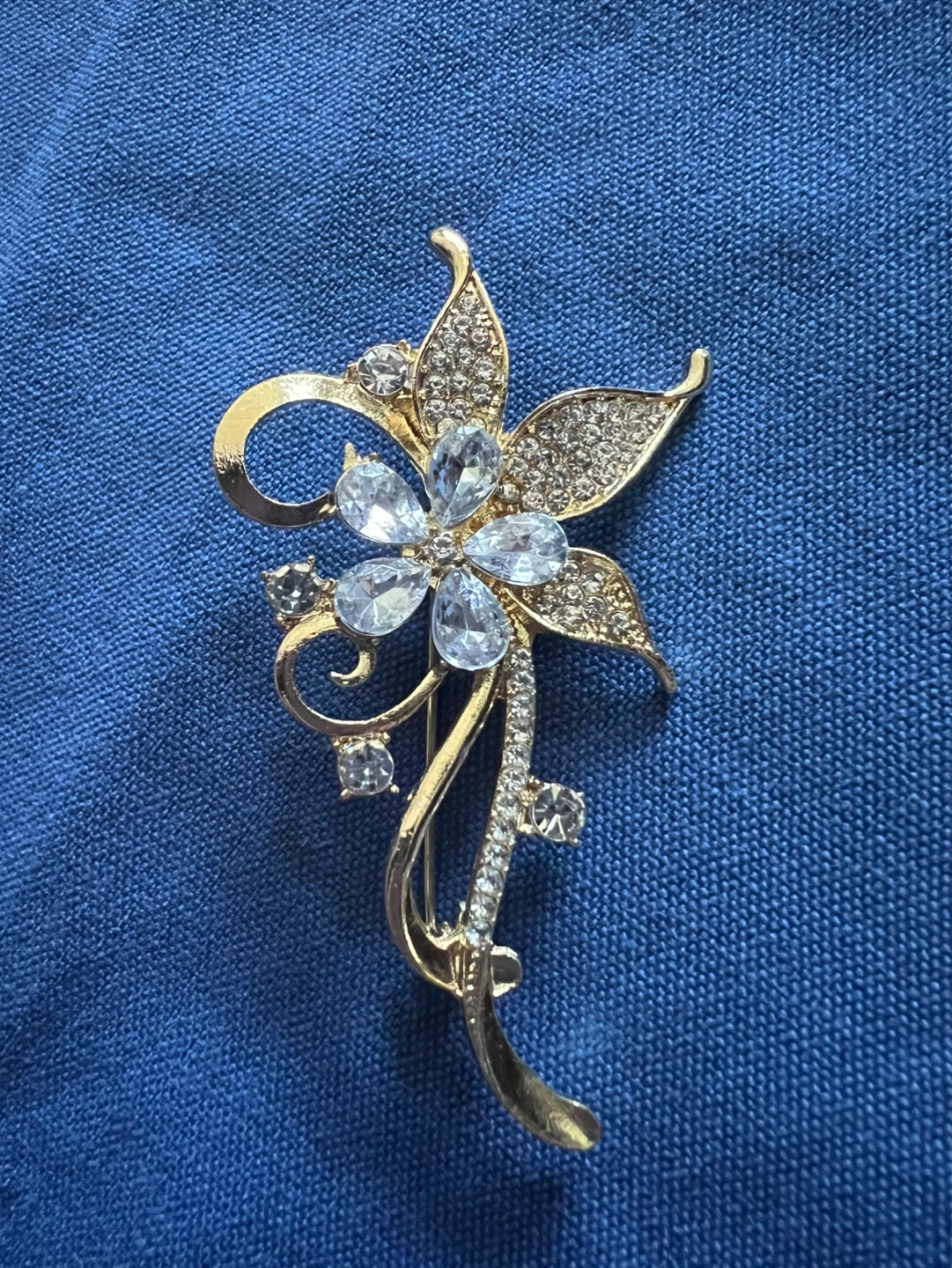 Gold-tone floral brooch with clear rhinestones