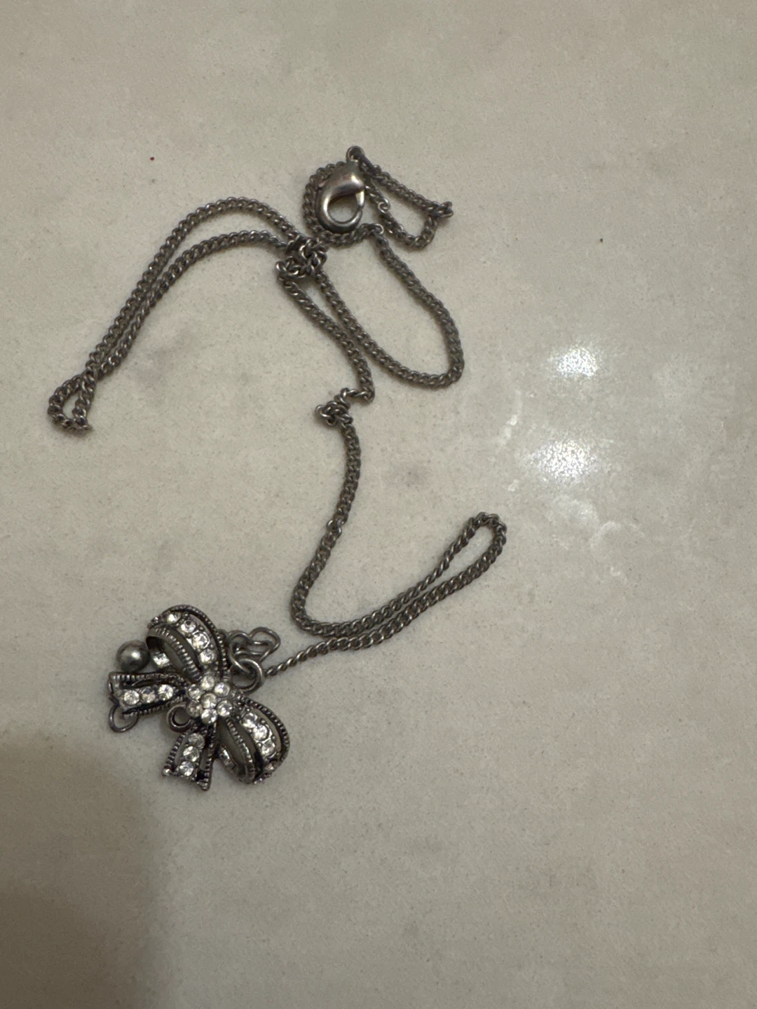 Silver Tone Bow Pendant Necklace with Rhinestones