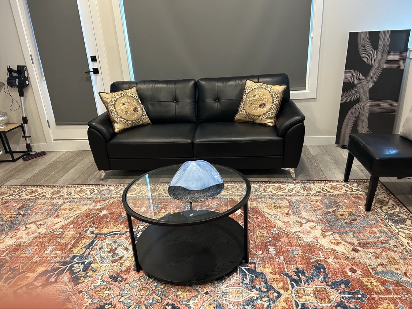 Black Leather Sofa with Decorative Pillows