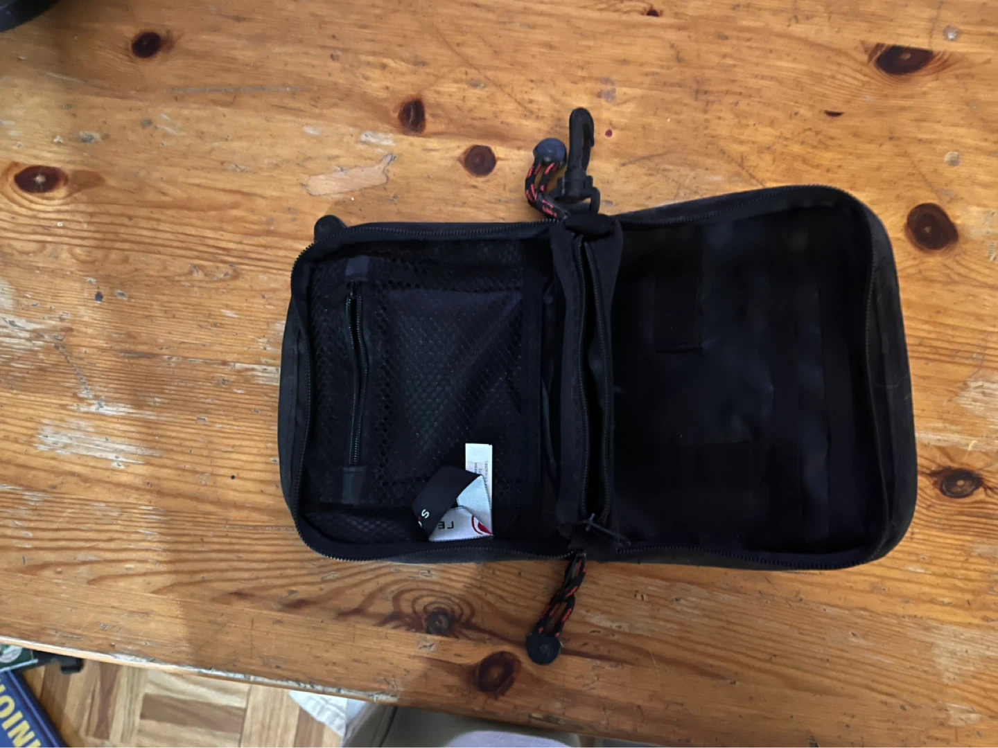 Black zippered travel pouch with clear ID window