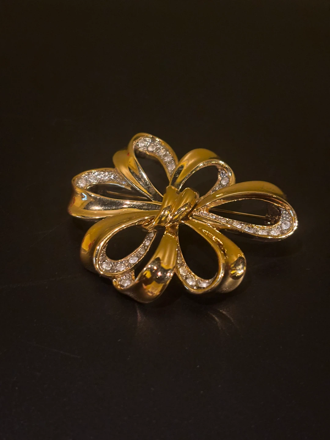 Gold tone bow brooch with rhinestones