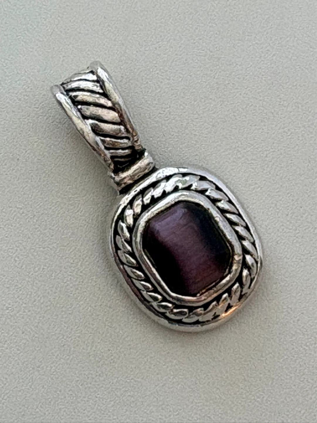 Silver Pendant with purple cat’s eye stone
