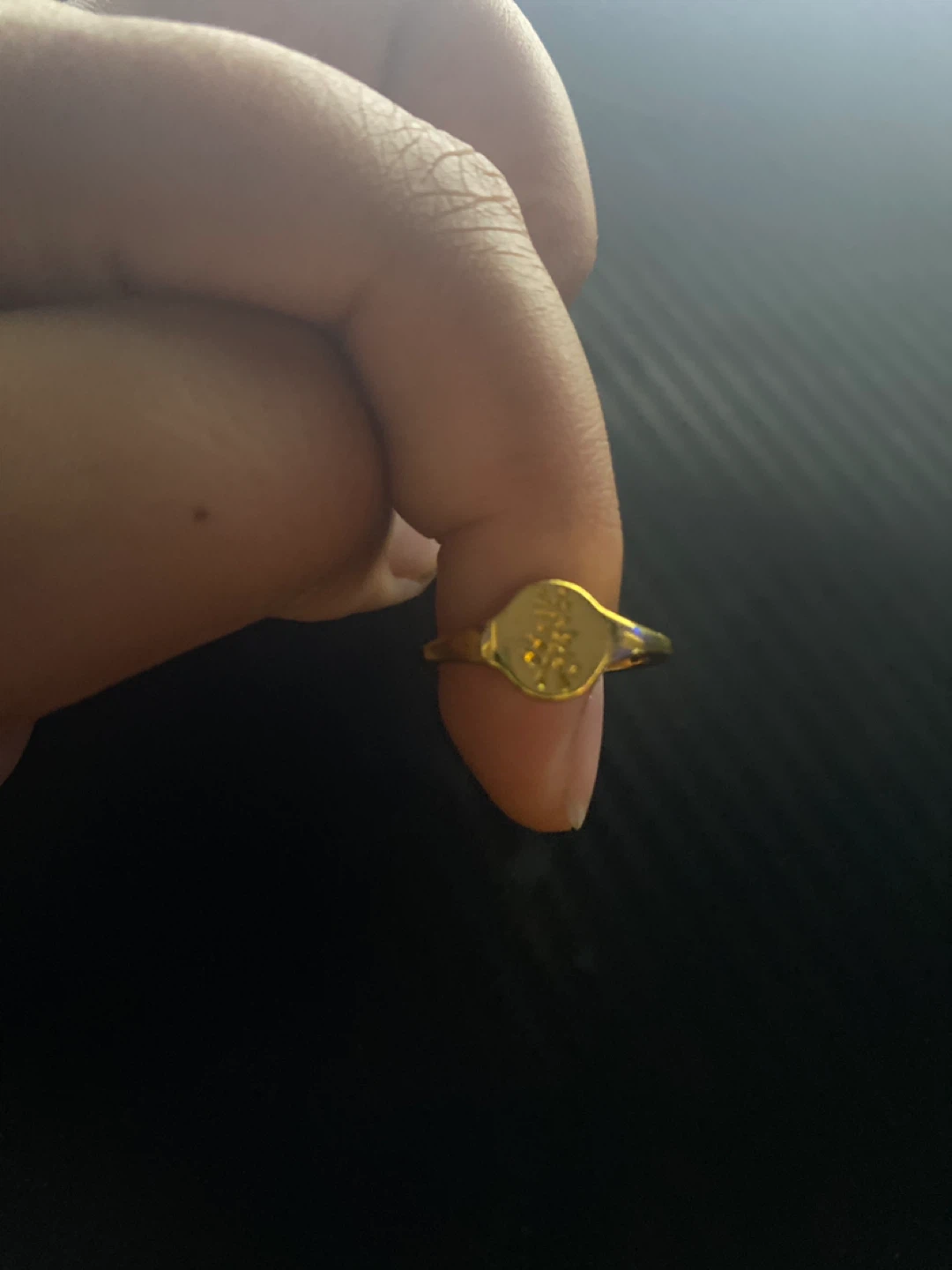 Gold tone ring with emblem