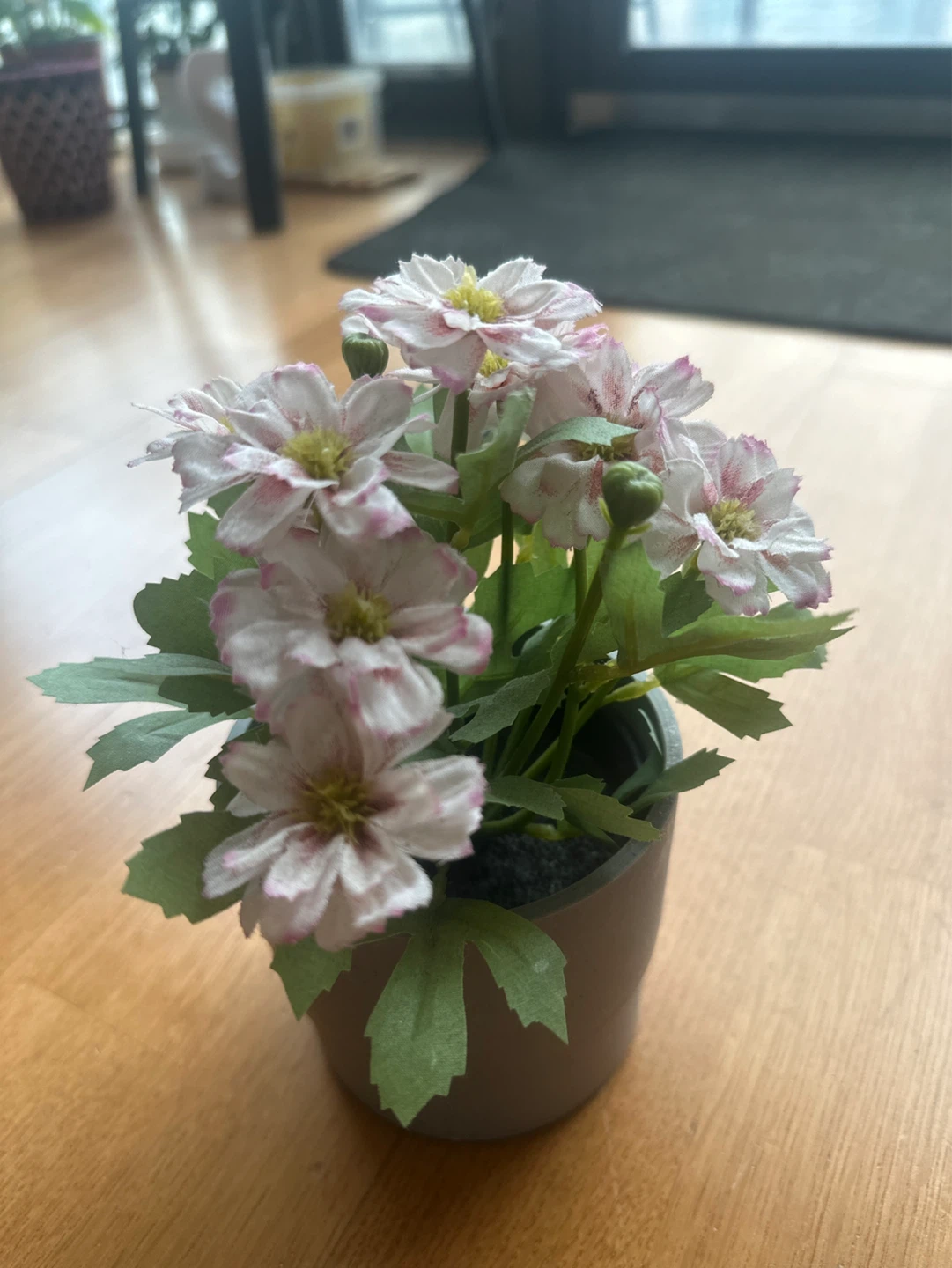Small artificial flower pot with pink and white flowers