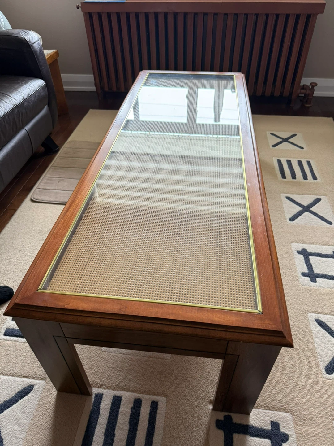 Wooden coffee table with glass and cane inlay