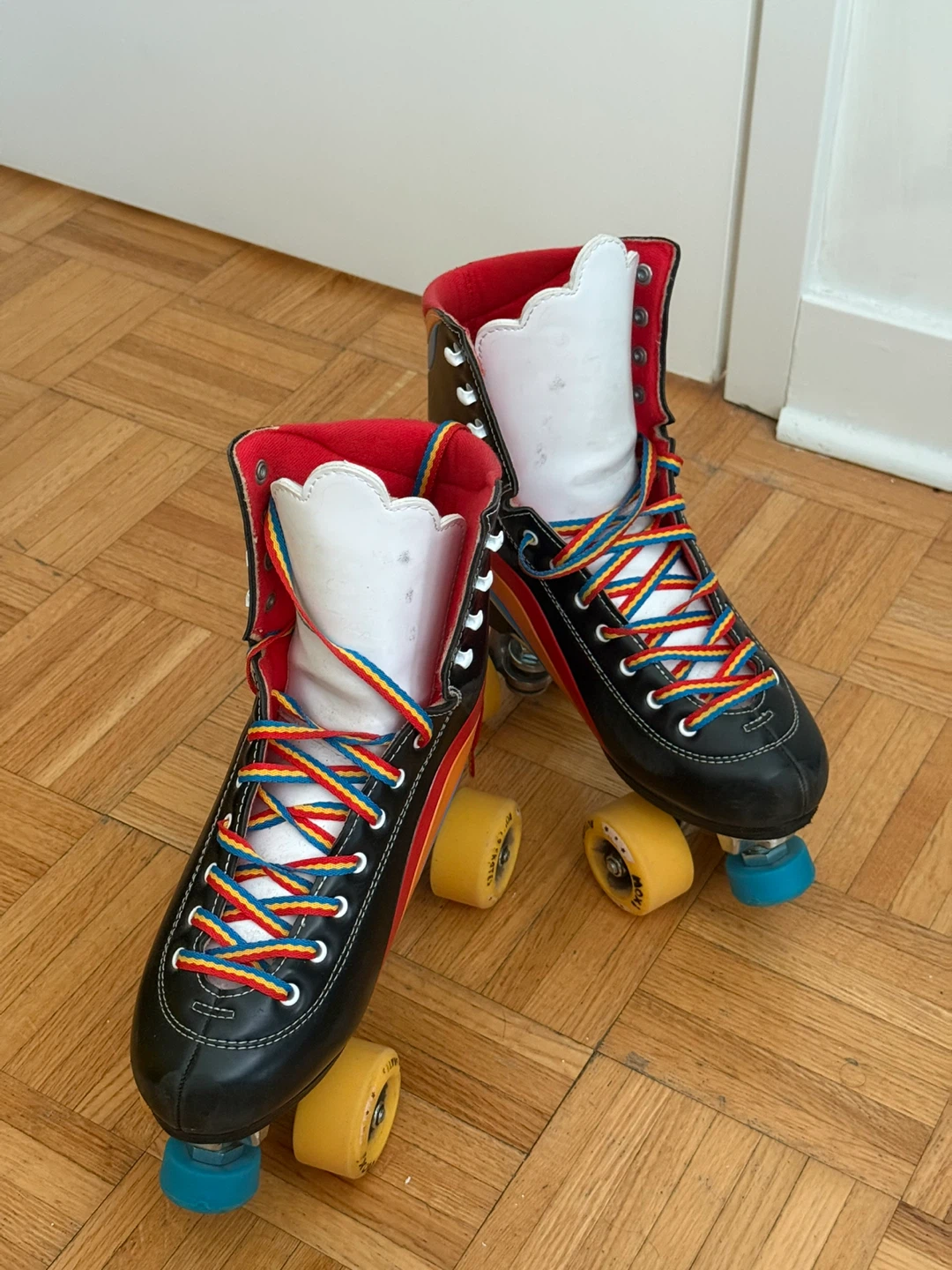 Moxi Black Roller Skates with Rainbow Laces