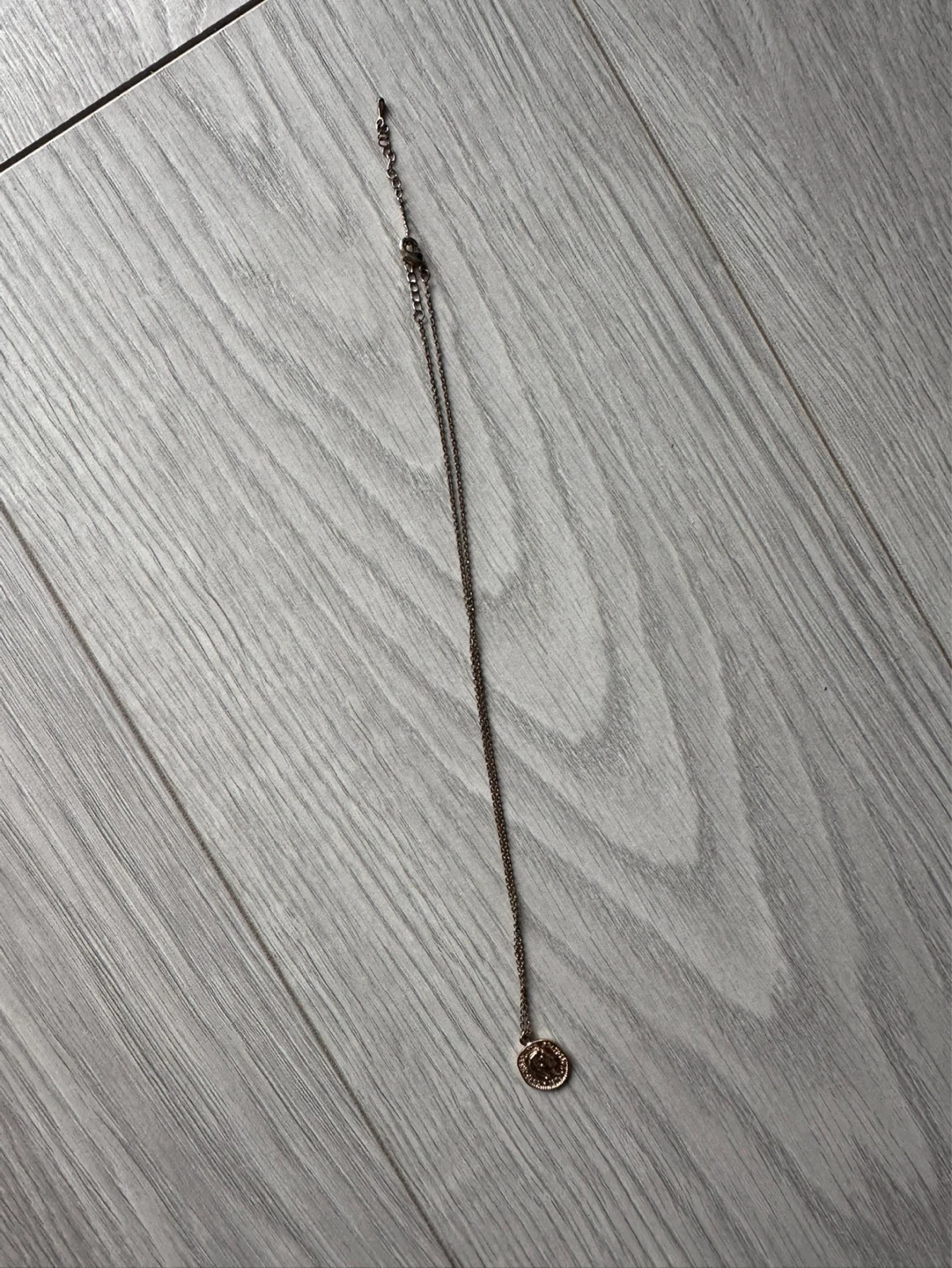 Gold tone pendant necklace with coin detail