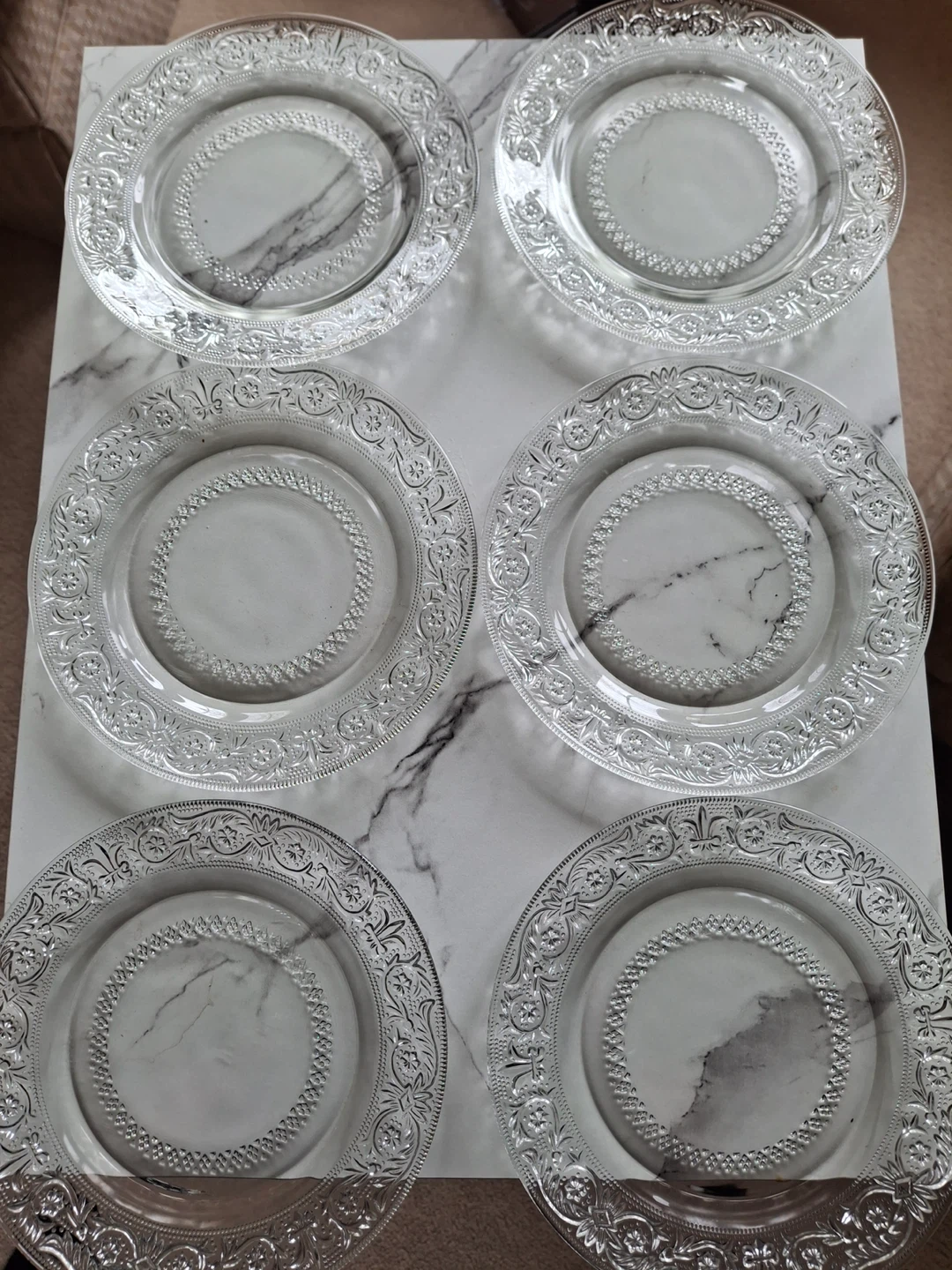 6 small clear glass plates with one matching shallow bowl